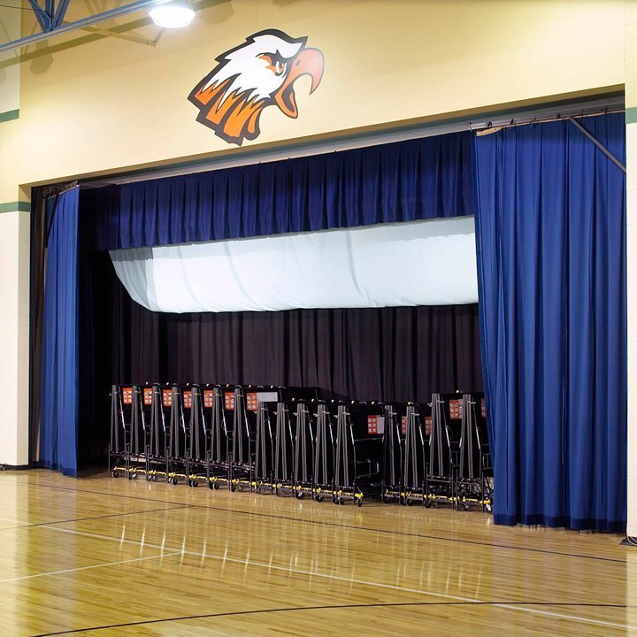 curtains being raised for insta-theatre in a school gymnasium