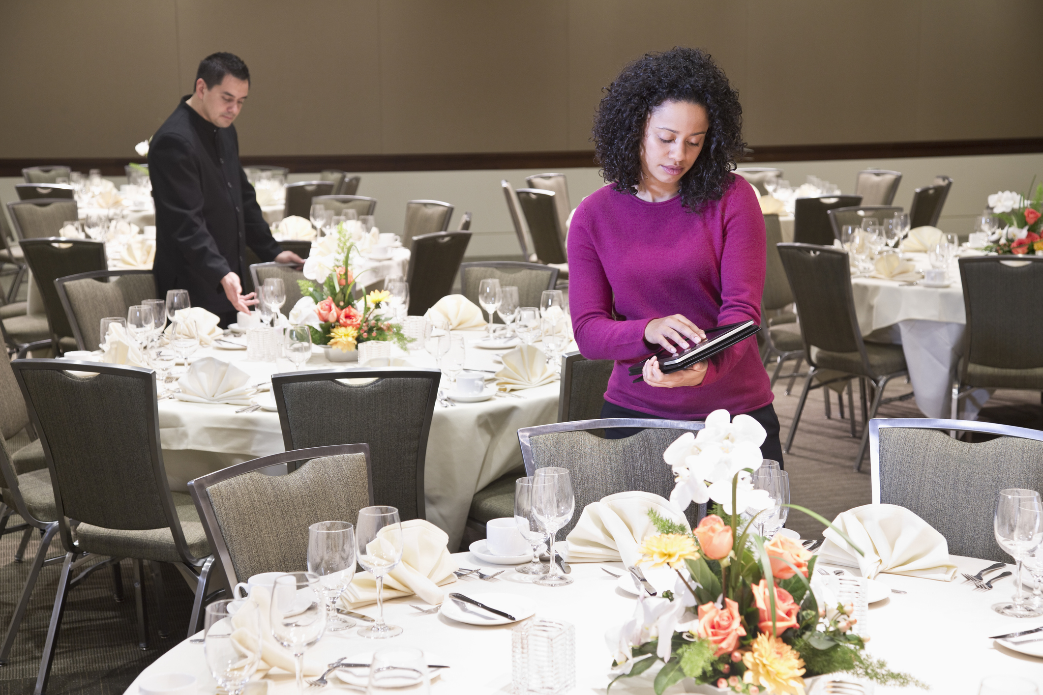 Businesswoman using tablet computer in dining room